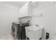 Laundry room featuring washer, dryer, utility sink, and storage cabinets at 103 Odin Dr, Winter Haven, FL 33884