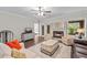 Cozy living room featuring a fireplace, neutral furniture, and hardwood flooring at 103 Odin Dr, Winter Haven, FL 33884