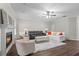 Bright living room features a fireplace, ceiling fan, and hardwood flooring at 103 Odin Dr, Winter Haven, FL 33884