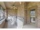 Relaxing covered patio with brick walls and comfortable seating for outdoor enjoyment at 103 Odin Dr, Winter Haven, FL 33884
