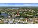 Magnificent aerial view of the desirable neighborhood, emphasizing the lush surroundings, community, and a placid lake at 1107 Almond Tree Cir, Orlando, FL 32835
