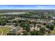 Expansive aerial view of a suburban neighborhood, highlighting lush landscaping, nearby lakes, and a distant city skyline at 1107 Almond Tree Cir, Orlando, FL 32835