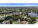Attractive aerial perspective of the community, revealing a tranquil lake, verdant trees, and desirable neighborhood streets at 1107 Almond Tree Cir, Orlando, FL 32835