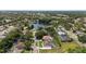 Aerial view of the community with a lake, mature trees, and well-maintained homes at 1107 Almond Tree Cir, Orlando, FL 32835