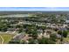 Wide aerial shot of the residential area, emphasizing its mature trees, peaceful lake, and appealing street layout at 1107 Almond Tree Cir, Orlando, FL 32835