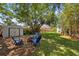 Private backyard oasis with mature trees, fire pit, storage shed and inviting seating area at 1107 Almond Tree Cir, Orlando, FL 32835