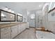 Bathroom with dual sinks, granite countertops, and a freestanding tub at 1107 Almond Tree Cir, Orlando, FL 32835