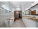 Bright bathroom with dual sinks, freestanding tub, and sliding barn door at 1107 Almond Tree Cir, Orlando, FL 32835
