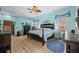 Bright bedroom featuring light blue walls, wooden floors, and a ceiling fan at 1107 Almond Tree Cir, Orlando, FL 32835