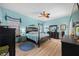 Light-filled bedroom with hardwood floors, ceiling fan, and light-blue walls at 1107 Almond Tree Cir, Orlando, FL 32835