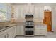 Well-lit kitchen with granite counters, subway tile backsplash, and stainless steel appliances at 1107 Almond Tree Cir, Orlando, FL 32835