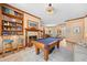 Inviting living room featuring a pool table, fireplace, and built-in bookshelves at 1107 Almond Tree Cir, Orlando, FL 32835