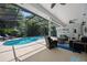 Inviting screened-in pool area featuring ample seating and lush landscaping for the ultimate outdoor living experience at 1107 Almond Tree Cir, Orlando, FL 32835