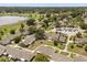 Expansive aerial view of well-maintained homes with lush landscaping and a large parking area near a serene lake at 1146 Villa Ln # 101, Apopka, FL 32712