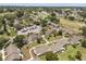 This aerial showcases a community with lush trees and landscaped yards and a parking area for the residents at 1146 Villa Ln # 101, Apopka, FL 32712