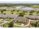 Drone shot of a home near a scenic pond and lush greenery at 1146 Villa Ln # 101, Apopka, FL 32712