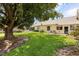 Large backyard with lush green grass, mature trees, and outdoor seating at 1146 Villa Ln # 101, Apopka, FL 32712