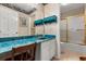 Vintage bathroom with a blue countertop, decorative wallpaper, and a separate shower/tub area at 1146 Villa Ln # 101, Apopka, FL 32712