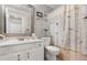 Cozy bathroom features a vanity, toilet, and shower with bird-themed curtain at 1146 Villa Ln # 101, Apopka, FL 32712