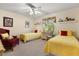 Cozy bedroom with two twin beds, colorful accents, and a window with bright natural light at 1146 Villa Ln # 101, Apopka, FL 32712