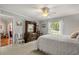 Spacious bedroom featuring a king bed, dresser, and a view leading to the en suite bathroom at 1146 Villa Ln # 101, Apopka, FL 32712