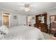 Bright bedroom features a king bed, dresser, and a view leading to the en suite bathroom at 1146 Villa Ln # 101, Apopka, FL 32712