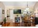 Cozy dining area featuring hardwood floors, a wooden table set, and adjacent view into the kitchen at 1146 Villa Ln # 101, Apopka, FL 32712