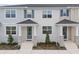 Charming townhouse featuring a cozy front porch and well-manicured landscaping, enhancing curb appeal at 1327 Tarflower Dr, Winter Springs, FL 32708