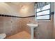 Cozy bathroom featuring a white pedestal sink and beautiful tile accents at 148 Olive Tree Cir # 148, Altamonte Springs, FL 32714