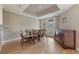 Formal dining room with elegant decor, with light filled windows and hardwood flooring at 148 Olive Tree Cir # 148, Altamonte Springs, FL 32714