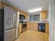 Well-lit kitchen features wood cabinets, stainless steel appliances, and a black dishwasher at 148 Olive Tree Cir # 148, Altamonte Springs, FL 32714