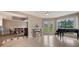 Bright living room with fireplace, a piano and beautiful flooring and dining area at 148 Olive Tree Cir # 148, Altamonte Springs, FL 32714