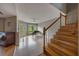 Spacious living room features a piano, staircase, wood floors, and doors leading to the backyard at 148 Olive Tree Cir # 148, Altamonte Springs, FL 32714