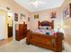 Bedroom with carpet, a bed, side table, window providing natural light, and connected bath at 1515 Cherry Lake Way, Lake Mary, FL 32746