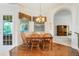 Cozy dining area featuring hardwood floors, a chandelier, and natural light from the window at 1515 Cherry Lake Way, Lake Mary, FL 32746