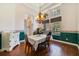 Elegant dining room featuring hardwood floors, decorative floral wallpaper, and a classic chandelier, creating a warm ambiance at 1515 Cherry Lake Way, Lake Mary, FL 32746