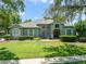 Beautiful home featuring mature trees, a green lawn, and manicured bushes at 1515 Cherry Lake Way, Lake Mary, FL 32746