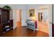Hallway with hardwood floors, neutral walls, leading to a bathroom and other rooms, plus a decorative console table at 1515 Cherry Lake Way, Lake Mary, FL 32746