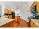 Charming kitchen with hardwood floors, wooden cabinetry, black appliances, and central island at 1515 Cherry Lake Way, Lake Mary, FL 32746
