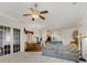 Open-concept living room with ceiling fan and views of the dining area and kitchen at 1515 Cherry Lake Way, Lake Mary, FL 32746