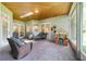 Inviting screened patio with brick flooring, wood-paneled ceiling, skylight, and comfortable seating area at 1515 Cherry Lake Way, Lake Mary, FL 32746