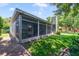 View of home's screened porch and manicured backyard at 1515 Cherry Lake Way, Lake Mary, FL 32746