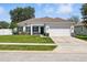 Charming single-story home with a well-manicured lawn and two car garage at 15411 Taurus Ct, Mascotte, FL 34753