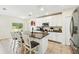 Kitchen island with seating and stainless appliances, microwave, and granite countertops at 15411 Taurus Ct, Mascotte, FL 34753