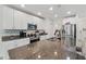 White cabinets and granite countertops are featured in this open kitchen at 15411 Taurus Ct, Mascotte, FL 34753