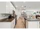 Kitchen with granite countertops, stainless appliances, and an island that offers seating at 15411 Taurus Ct, Mascotte, FL 34753