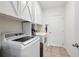 Well-equipped laundry room with washer, dryer, and ample cabinet space at 15411 Taurus Ct, Mascotte, FL 34753