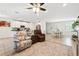 Open living room with views of the kitchen, light tile flooring and lots of seating at 15411 Taurus Ct, Mascotte, FL 34753