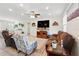 Large living room features comfortable couches and a large television for entertaining at 15411 Taurus Ct, Mascotte, FL 34753