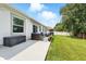 Patio with cozy blue seating, storage box, well-kept lawn, and an open outdoor space at 15411 Taurus Ct, Mascotte, FL 34753